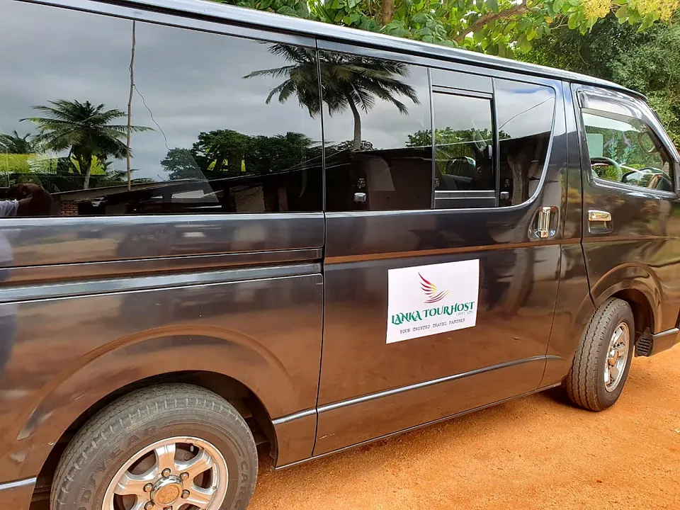 Grey Toyota Hiace van with the Lanka Tour Host sign on its side