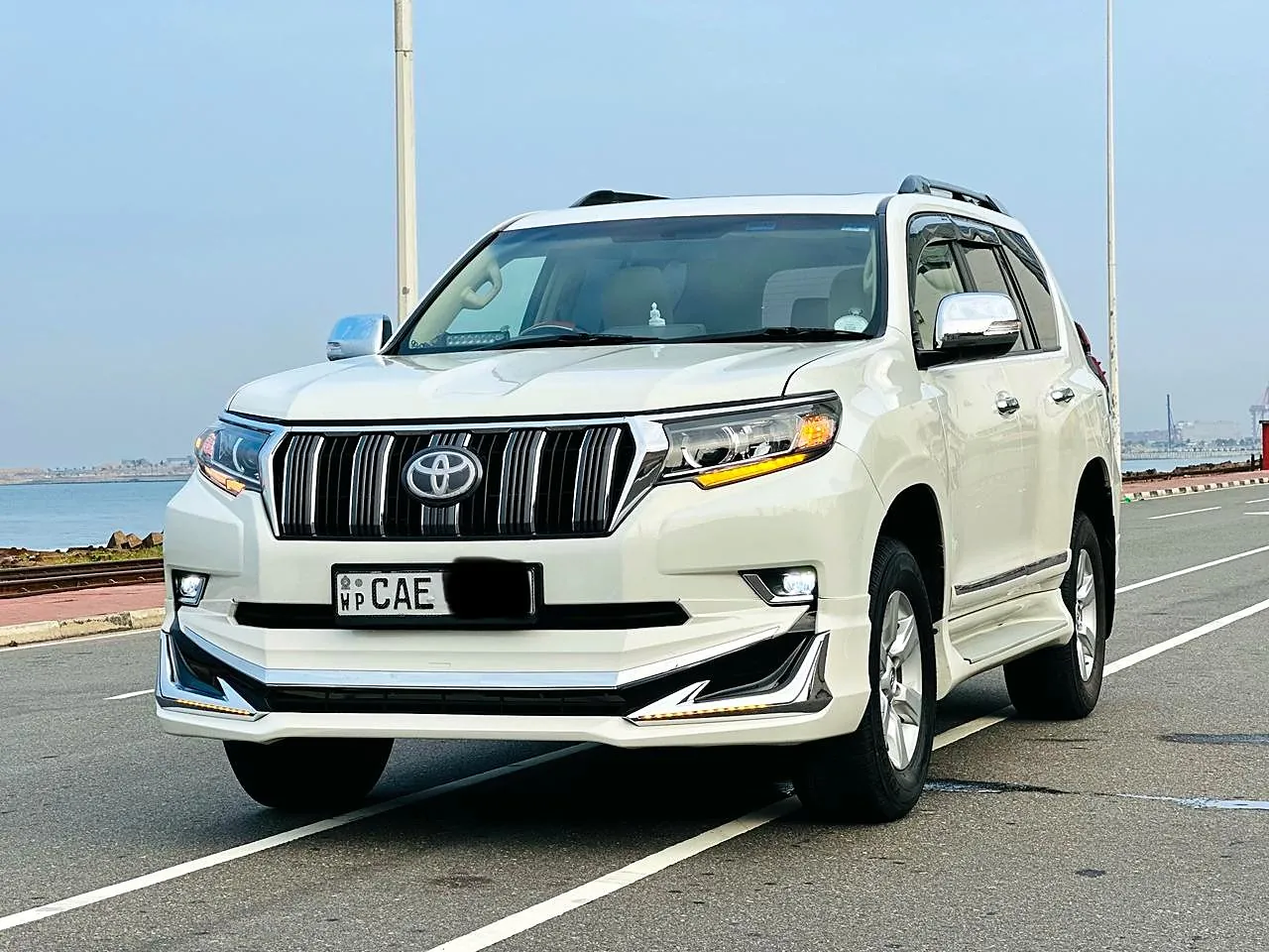 White Toyota Prado of our fleet on the seafront road in Colombo